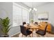 Bright dining room with a round table, four chairs, and a large window at 2225 Santini Trl # C, Littleton, CO 80129
