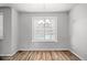 Bright dining room with hardwood floors, a window, and a stylish chandelier at 2225 Santini Trl # C, Littleton, CO 80129