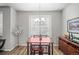 Comfortable dining area with a window, a wooden table, and a bar cabinet at 2225 Santini Trl # C, Littleton, CO 80129