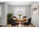 Cozy dining area featuring a round table, four chairs, and a leafy plant at 2225 Santini Trl # C, Littleton, CO 80129