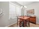 Cozy dining area with a wooden table, a bar cabinet, and a large window at 2225 Santini Trl # C, Littleton, CO 80129