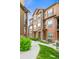 View of the townhomes showing the manicured lawn and path to the homes at 2225 Santini Trl # C, Littleton, CO 80129
