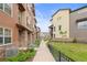 Stunning exterior view of modern townhomes featuring stone accents and well-manicured landscaping at 2225 Santini Trl # C, Littleton, CO 80129