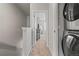 Bright hallway with laundry machines to the right at 2225 Santini Trl # C, Littleton, CO 80129