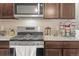 Close up of kitchen featuring stainless steel appliances, granite countertops, and tile backsplash at 2225 Santini Trl # C, Littleton, CO 80129