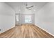 Bright, empty living room featuring hardwood floors, a ceiling fan, and large windows at 2225 Santini Trl # C, Littleton, CO 80129