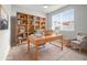 Well-lit office space featuring a large desk, bookshelves, and a comfortable chair at 2225 Santini Trl # C, Littleton, CO 80129