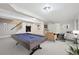 Finished basement showcasing a billiards table, seating, and bar area at 8773 S Dudley St, Littleton, CO 80128