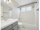 Bathroom featuring granite countertop vanity and shower-tub at 8773 S Dudley St, Littleton, CO 80128