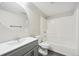 This bathroom features a bath tub, a toilet, and a vanity with a mirror at 8773 S Dudley St, Littleton, CO 80128