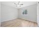 Bedroom featuring light hardwood floors, ceiling fan and a window at 8773 S Dudley St, Littleton, CO 80128