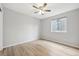 Bedroom featuring light hardwood floors, ceiling fan and window at 8773 S Dudley St, Littleton, CO 80128