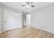 Bright bedroom featuring hardwood floors, closet, and ceiling fan at 8773 S Dudley St, Littleton, CO 80128