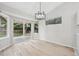 Dining room with light hardwood floors, modern light fixture and backyard views at 8773 S Dudley St, Littleton, CO 80128