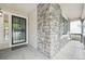 Welcoming front entrance with stone accents, a secure gate, and bright, clean design at 8773 S Dudley St, Littleton, CO 80128