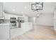 Modern kitchen with stainless steel appliances and center island with white cabinets at 8773 S Dudley St, Littleton, CO 80128