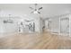 Bright, open-concept living room with hardwood floors leading into an updated kitchen at 8773 S Dudley St, Littleton, CO 80128