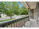 Inviting front porch with a view of the street, stone detailing, and decorative railings at 8773 S Dudley St, Littleton, CO 80128