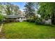 Lush backyard featuring mature trees and covered patio, creating a serene outdoor space at 3231 S Elati St, Englewood, CO 80110