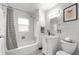 Clean bathroom with tiled shower, modern vanity, and ample lighting at 3231 S Elati St, Englewood, CO 80110