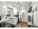 Bright kitchen with white cabinets, stainless steel appliances, and ample counter space for cooking at 3231 S Elati St, Englewood, CO 80110