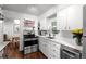 Bright kitchen with stainless steel appliances, white cabinets, and open shelving at 3231 S Elati St, Englewood, CO 80110