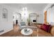 Spacious living room with hardwood floors, stylish furniture, and natural light from nearby windows at 3231 S Elati St, Englewood, CO 80110