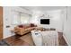 Cozy living room with hardwood floors, leather sofa, textured rug, and lots of natural light at 3231 S Elati St, Englewood, CO 80110