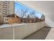 Spacious balcony with a concrete wall, offering views of surrounding neighborhood and buildings at 1250 N Humboldt St # 202, Denver, CO 80218