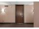 Neutral condo entrance featuring an exit sign, apartment number, and hardwood door at 1250 N Humboldt St # 202, Denver, CO 80218