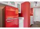 Retro kitchen showcasing a bright red refrigerator and classic white cabinets at 1250 N Humboldt St # 202, Denver, CO 80218