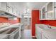 Functional kitchen with white cabinets and a view into an adjacent living area at 1250 N Humboldt St # 202, Denver, CO 80218