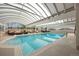 Indoor swimming pool with seating areas and a transparent roof providing natural light at 1250 N Humboldt St # 202, Denver, CO 80218