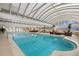 Indoor swimming pool with seating areas and a transparent roof providing natural light at 1250 N Humboldt St # 202, Denver, CO 80218