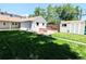 Large backyard with grass, shed, hot tub, and brick patio at 1054 Magnolia St, Denver, CO 80220