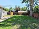Grassy backyard featuring a wooden fence and mature trees at 1054 Magnolia St, Denver, CO 80220