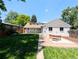 Exterior view of home with a lush lawn, brick patio, and hot tub at 1054 Magnolia St, Denver, CO 80220