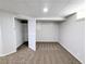 Finished basement featuring neutral carpeting, paneled walls, and closet space at 1054 Magnolia St, Denver, CO 80220