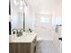 Bathroom with modern vanity, hexagon tile floor, shower with white tile and grab bar at 1054 Magnolia St, Denver, CO 80220