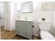 Bathroom featuring green vanity, with toilet and vintage tile at 1054 Magnolia St, Denver, CO 80220