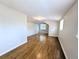 Upstairs bonus room with wood floors, window with blinds, and clean white paint at 1054 Magnolia St, Denver, CO 80220