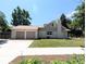 Exterior view of home with a two-car garage, sidewalk, and manicured lawn at 1054 Magnolia St, Denver, CO 80220