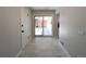 Neutral hallway with tile floors and a sliding glass door to the backyard at 1054 Magnolia St, Denver, CO 80220