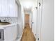 Hallway with hardwood floors and white trim, leading to multiple rooms in the house at 1054 Magnolia St, Denver, CO 80220