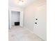 Bright hallway featuring tile floors, a closet, and clean white paint at 1054 Magnolia St, Denver, CO 80220