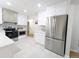 Updated kitchen features stainless steel appliances and white cabinetry at 1054 Magnolia St, Denver, CO 80220