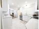 Bright kitchen with white cabinets, a stainless steel dishwasher, and an adjacent dining area at 1054 Magnolia St, Denver, CO 80220