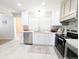 Bright kitchen featuring white cabinets, stainless steel appliances, and stylish backsplash at 1054 Magnolia St, Denver, CO 80220