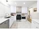Modern kitchen featuring white cabinets and stainless steel appliances at 1054 Magnolia St, Denver, CO 80220