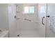 Clean, modern shower with a window, safety bar, and tiled surround at 1054 Magnolia St, Denver, CO 80220